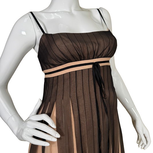 sleeveless thrifted BCBG Maxazria Silk Babydoll Dress with Slitted Sheer Overlay features delicate spaghetti straps and a flattering empire waistline accented by a thin ribbon.