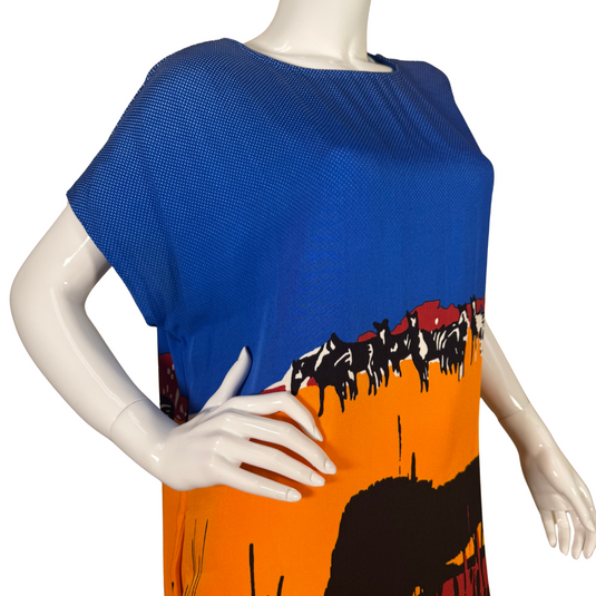 pre-loved Diane Von Furstenberg Unique Blue Dress with Safari Themed Design features a striking African safari-inspired print, showcasing a stunning sunset gradient transitioning from deep blue to fiery orange and red