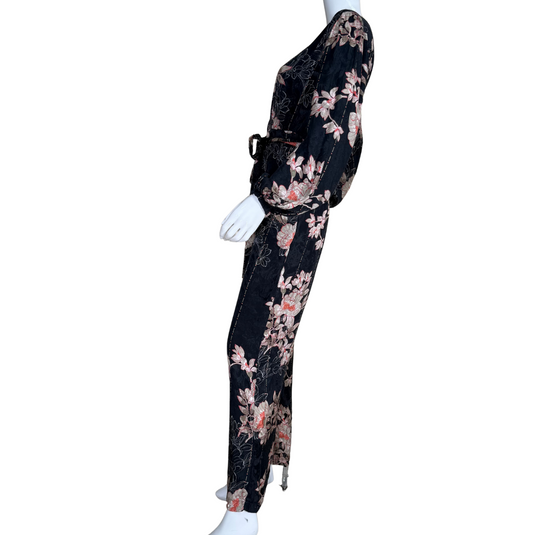Mannequin wearing a black floral jumpsuit on a white background
