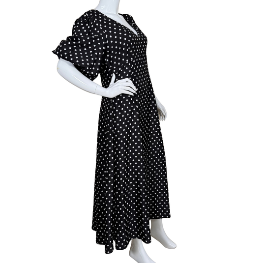 Black polka dot dress on a mannequin against a white background