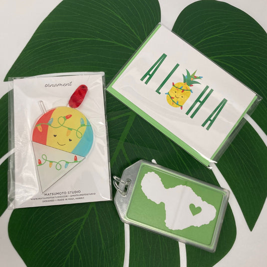 Aloha Christmas Shave Ice Set - ShopYWCA; shave ice ornament, greeting card, and maui luggage tag on leaf