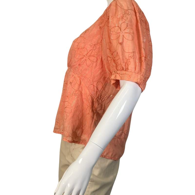 Load image into Gallery viewer, Amandi Orange Embroidered Blouse with Flowers is a women’s short-sleeve blouse in a warm orange color, featuring an embroidered floral design - side view
