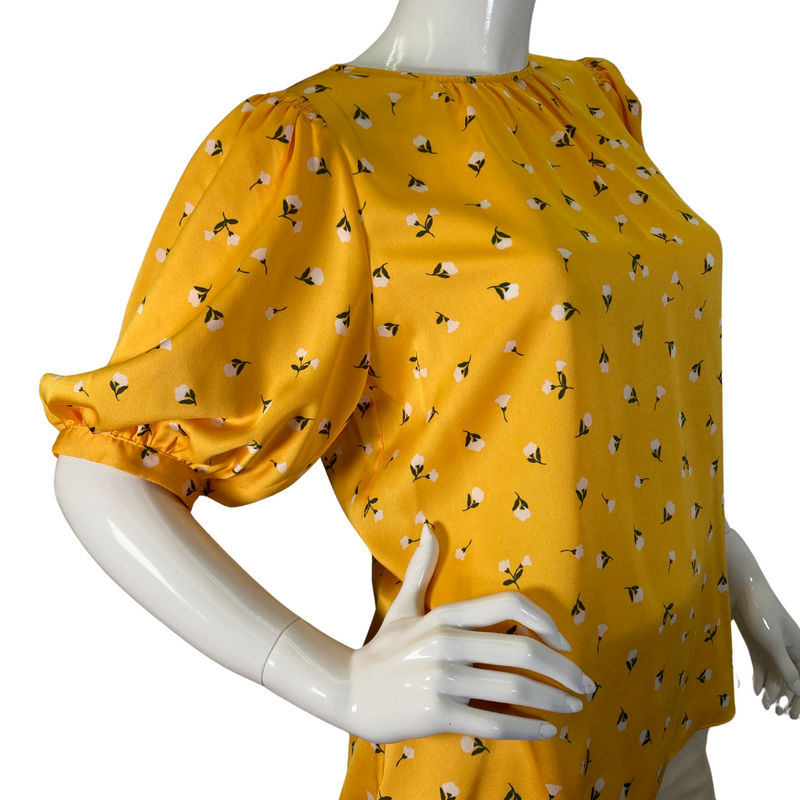 Load image into Gallery viewer,  Kate Spade Vibrant Yellow Blouse Featuring Small White Flowers is a cheerful, mustard-yellow blouse featuring a delicate floral print throughout - side view
