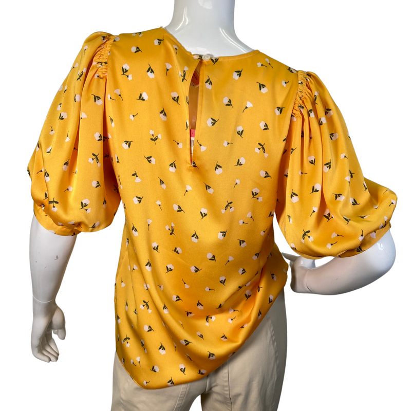 Load image into Gallery viewer,  Kate Spade Vibrant Yellow Blouse Featuring Small White Flowers is a cheerful, mustard-yellow blouse featuring a delicate floral print throughout - backside view
