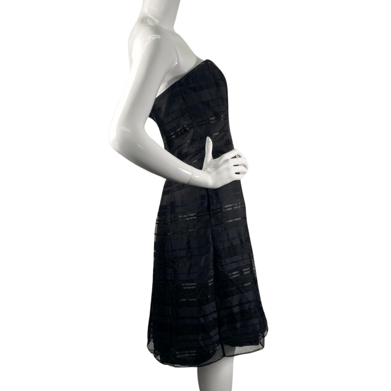 Load image into Gallery viewer, White House Black Market Strapless Layered Black Dress Cocktail Dress, knee-length piece is made of lightweight fabric with a semi-sheer overlay- side view 
