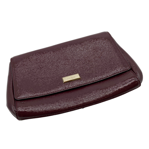 Kate Spade Burgundy Leather Clutch - handbag with a sophisticated design. The bag is crafted from textured leather and features a flap closure with a gold-tone Kate Spade logo plate on the front - front view