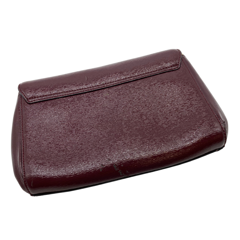 Load image into Gallery viewer, Kate Spade Burgundy Leather Clutch - handbag with a sophisticated design. The bag is crafted from textured leather and features a flap closure with a gold-tone Kate Spade logo plate on the front - backside view
