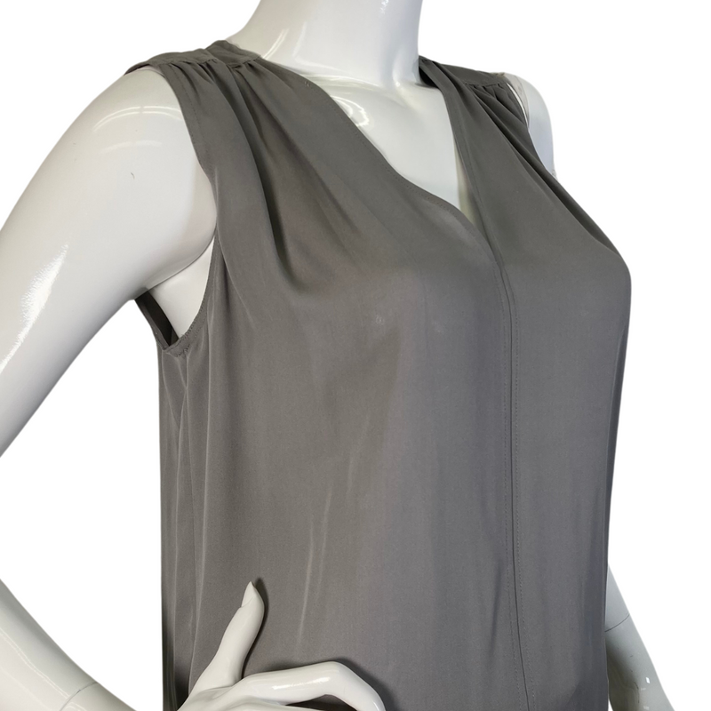 Load image into Gallery viewer, Vince Light Grey Blouse is a sleek, sleeveless gray blouse with a V-neckline and subtle pleating at the shoulders for added elegance - close up side view
