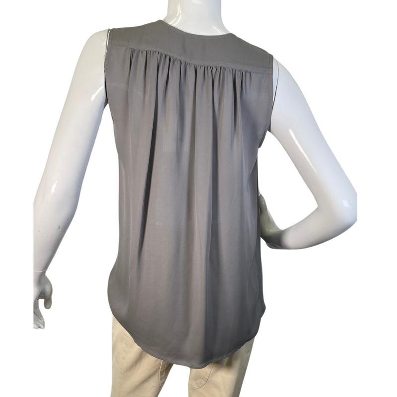 Load image into Gallery viewer, Vince Light Grey Blouse is a sleek, sleeveless gray blouse with a V-neckline and subtle pleating at the shoulders for added elegance - backside view
