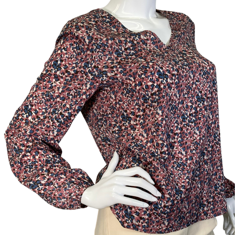 Load image into Gallery viewer, Eden In Love Dusty Pink Leopard Blouse is a long-sleeve, V-neck blouse with a multicolored abstract floral pattern in shades of red, pink, navy blue, and white - side view
