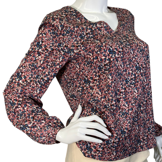 Eden In Love Dusty Pink Leopard Blouse is a long-sleeve, V-neck blouse with a multicolored abstract floral pattern in shades of red, pink, navy blue, and white - side view