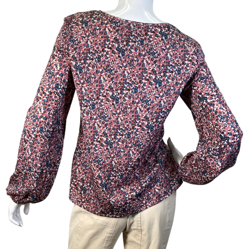 Load image into Gallery viewer, Eden In Love Dusty Pink Leopard Blouse is a long-sleeve, V-neck blouse with a multicolored abstract floral pattern in shades of red, pink, navy blue, and white - backside view
