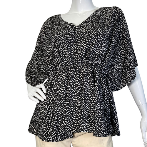 Eden In Love Polka Dot Black and White Blouse is a stylish, flowy black and white blouse featuring an abstract dotted pattern - front view