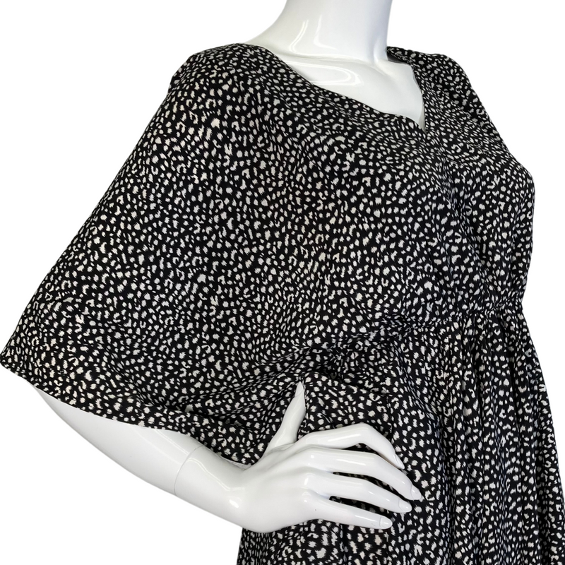 Load image into Gallery viewer, Eden In Love Polka Dot Black and White Blouse is a stylish, flowy black and white blouse featuring an abstract dotted pattern - side view
