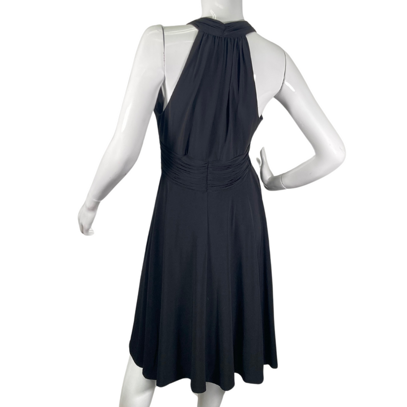 Load image into Gallery viewer, Evan Picone Black Dress with Elastic Waist is a knee-length halter dress, featuring a plunging V-neckline and ruched detailing along the bodice for a flattering fit - backside view
