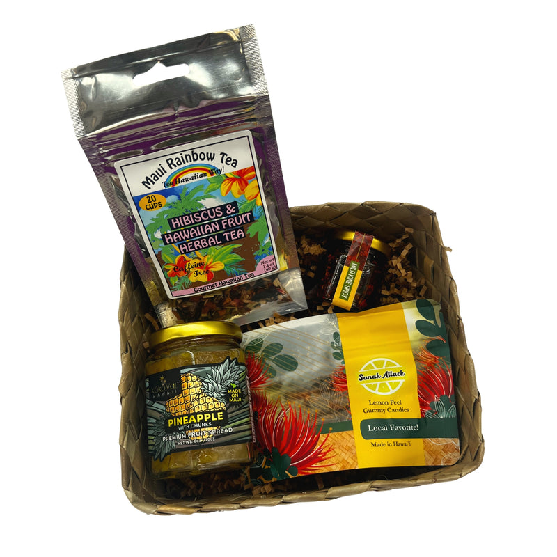 Load image into Gallery viewer, ShopYWCA Foodie Faves Basket with maui rainbow hibiscus &amp; hawaiian fruit herbal tea koko val hawaii pineapple premium fruit spread maui chili chili oil sanak attack lemon peel gummy candies top view in basket
