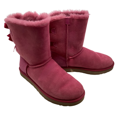 UGG Pink Boots with a Cute Bows in a vibrant pink shade, featuring a suede exterior and plush sheepskin lining for warmth and comfort 