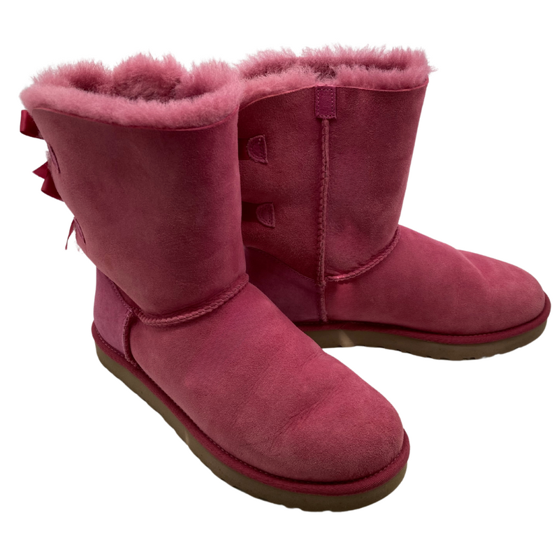 Load image into Gallery viewer, UGG Pink Boots with a Cute Bows in a vibrant pink shade, featuring a suede exterior and plush sheepskin lining for warmth and comfort 
