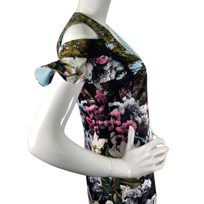 Load image into Gallery viewer, Ted Baker Dress in Light Blue with Lakescape and Floral Garden&nbsp;is a stylish short-sleeve dress featuring a vibrant nature-inspired print - side view close-up
