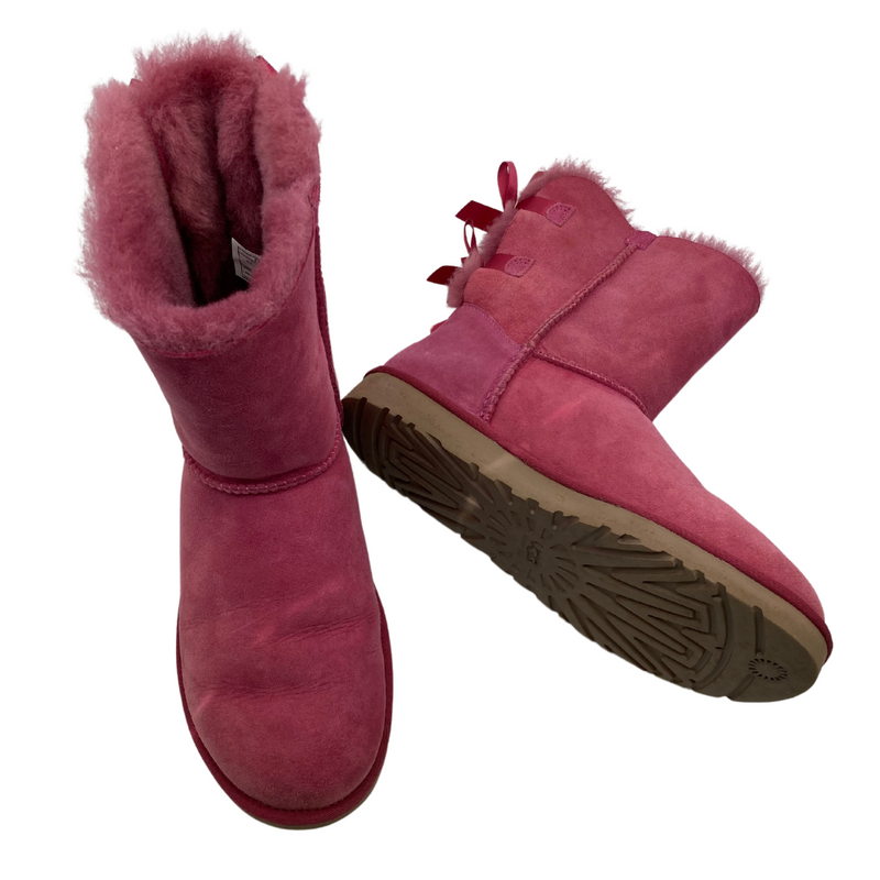 Load image into Gallery viewer, UGG Pink Boots with a Cute Bows in a vibrant pink shade, featuring a suede exterior and plush sheepskin lining for warmth and comfort
