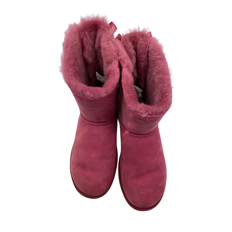 Load image into Gallery viewer, UGG Pink Boots with a Cute Bows in a vibrant pink shade, featuring a suede exterior and plush sheepskin lining for warmth and comfort - top view
