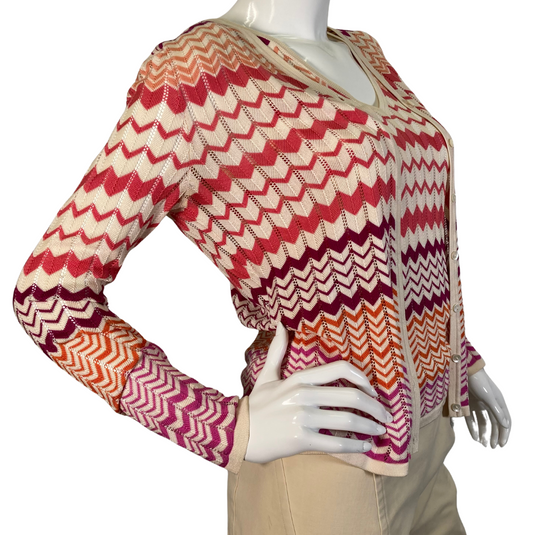 Neiman Marcus Exclusive Silk Tank Top and Sweater is a lightweight women’s cardigan featuring a vibrant zigzag pattern in shades of red, orange, and cream - side view