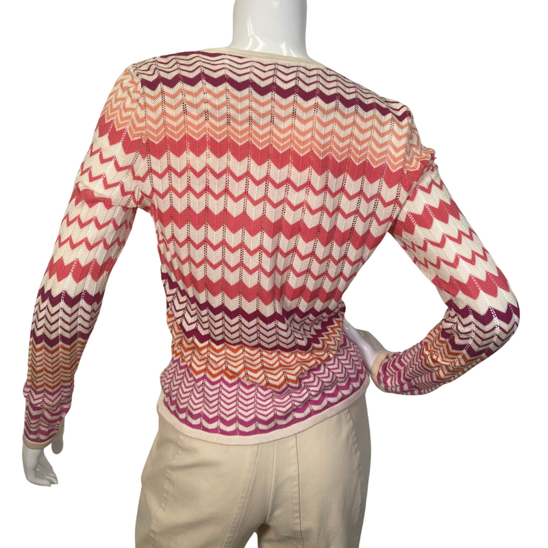 Load image into Gallery viewer, Neiman Marcus Exclusive Silk Tank Top and Sweater is a lightweight women’s cardigan featuring a vibrant zigzag pattern in shades of red, orange, and cream - backside view
