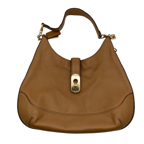 Coach Tan Leather Hobo Bag has a relaxed, slouchy silhouette. The bag features a wide adjustable shoulder strap with gold-tone hardware and clip attachments for a stylish, versatile look - front view