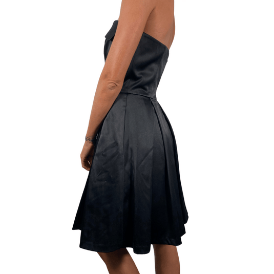 White House Black Market Chic Black Cocktail Dress features a fitted bodice with a fold-over neckline for added elegance - side view