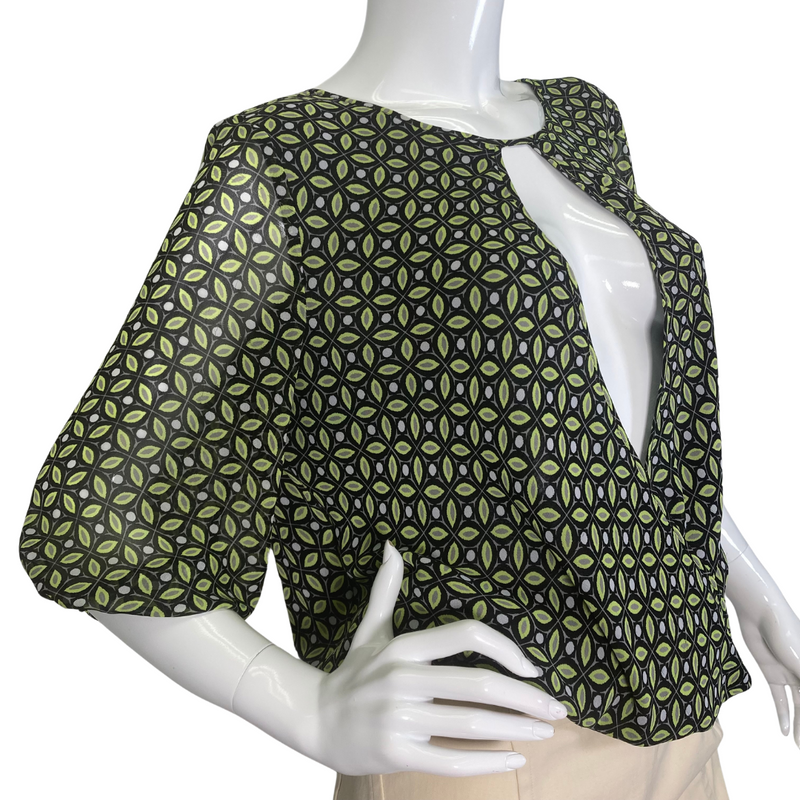 Load image into Gallery viewer, Vince Camuto Sheer Blouse with Opened V-shaped Cutout is a stylish women’s blouse featuring a unique geometric pattern in shades of green and black - side view
