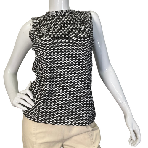 Maeve by Antrhropologie Black and White Eye-catching Knit Tank top is a sleeveless women’s top with a high neckline, featuring a black-and-white open-knit pattern - front view