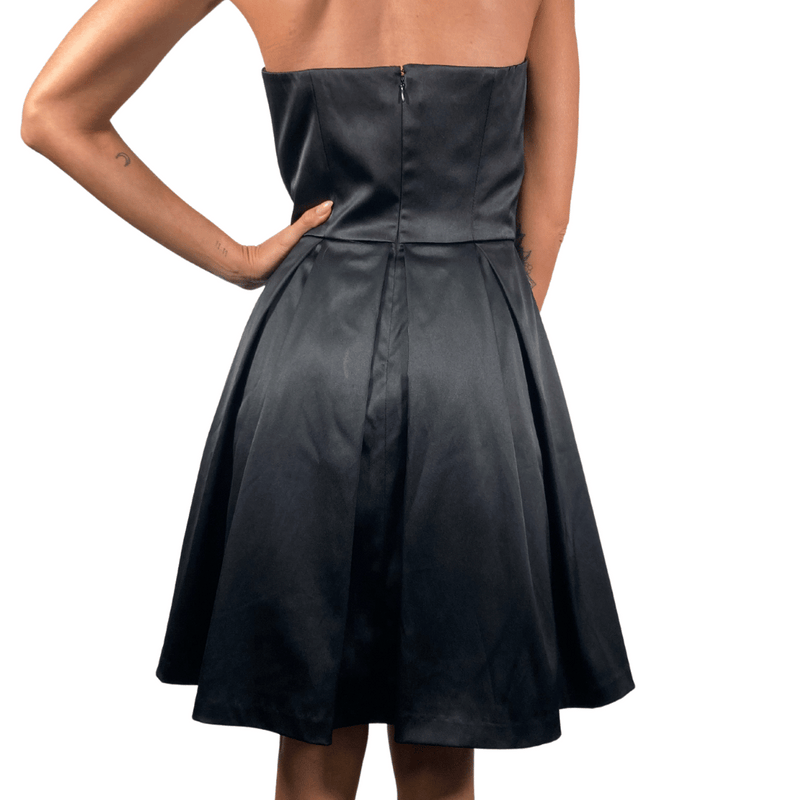 Load image into Gallery viewer, White House Black Market Chic Black Cocktail Dress features a fitted bodice with a fold-over neckline for added elegance - backside view
