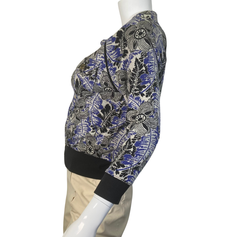 Load image into Gallery viewer, uicy Couture Abstract floral Jacket in black, blue and White with Gold Threading is a stylish, fitted jacket with a vibrant floral and botanical print in shades of blue, green, and purple - side view
