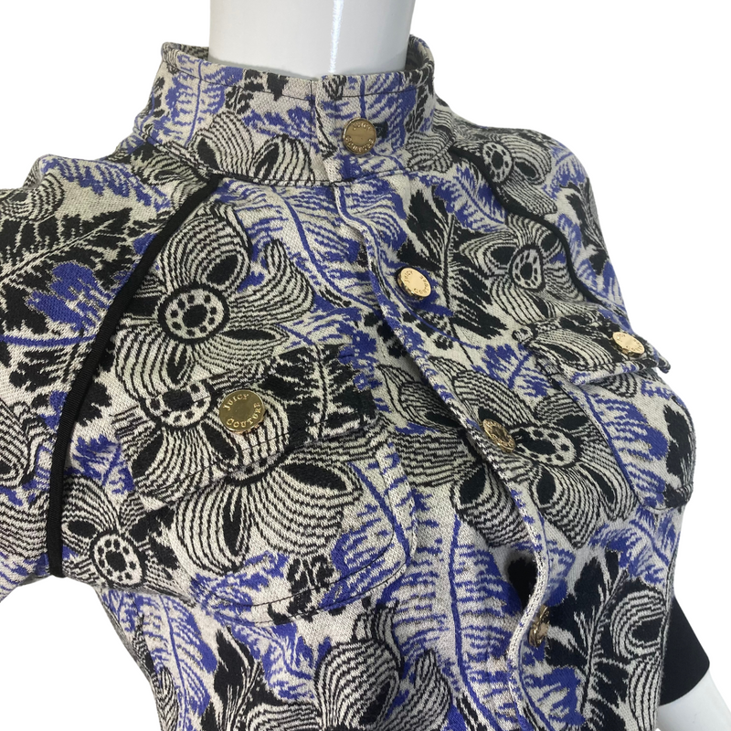 Load image into Gallery viewer, uicy Couture Abstract floral Jacket in black, blue and White with Gold Threading is a stylish, fitted jacket with a vibrant floral and botanical print in shades of blue, green, and purple - close-up view
