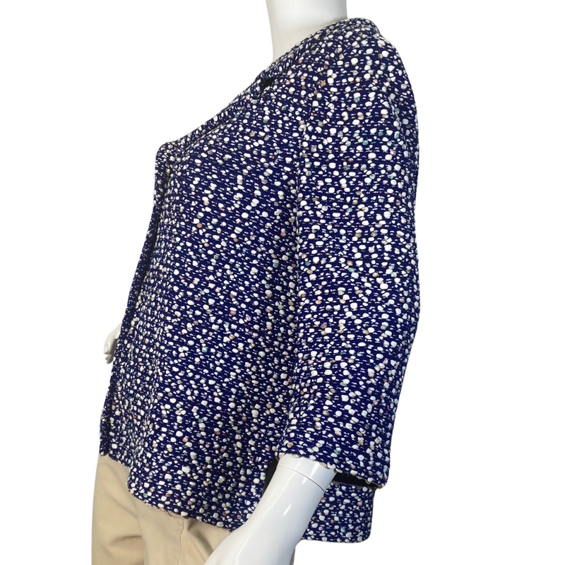 Load image into Gallery viewer,  St. John Warm Playful Blue and White Coat Jacket is a women’s button-up blouse with a multi-colored polka-dot like pattern on a dark background - side view
