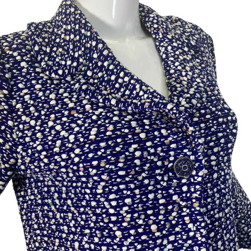 Load image into Gallery viewer, St. John Warm Playful Blue and White Coat Jacket is a women’s button-up blouse with a multi-colored polka-dot like pattern on a dark background - close up view
