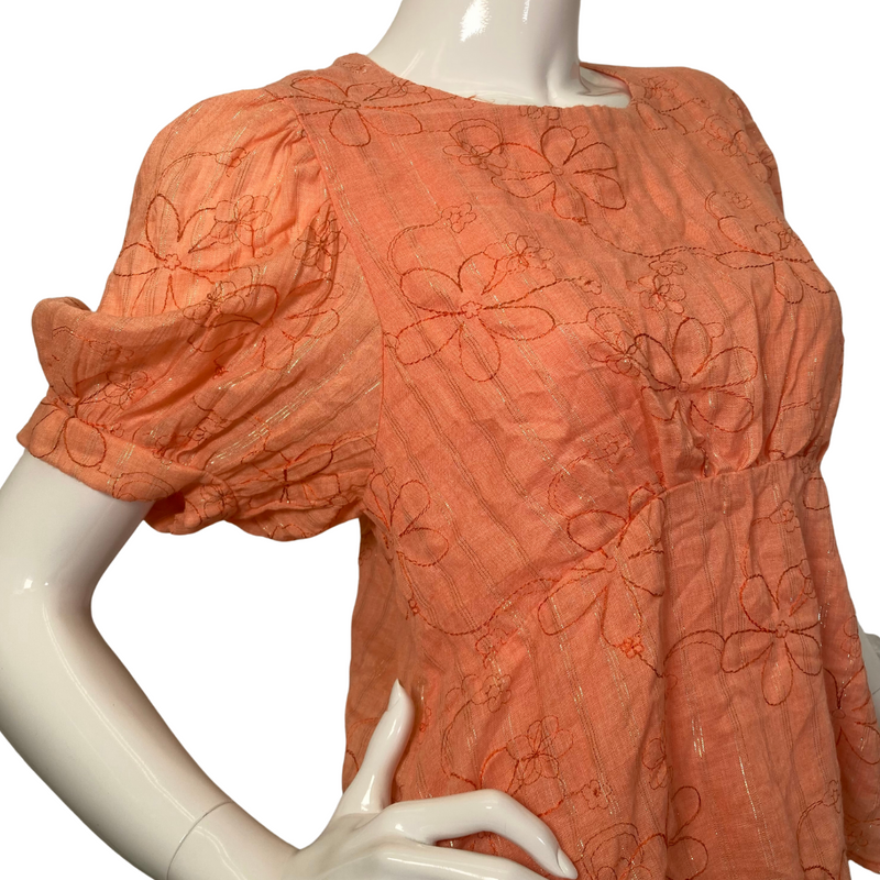 Load image into Gallery viewer, Amandi Orange Embroidered Blouse with Flowers is a women’s short-sleeve blouse in a warm orange color, featuring an embroidered floral design - side view
