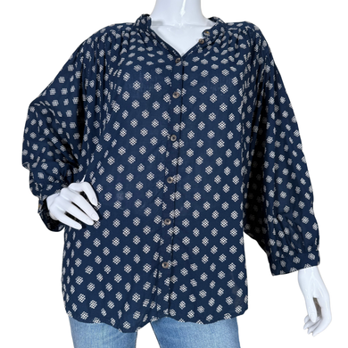 Navy blue patterned shirt on a mannequin with white gloves against a white background