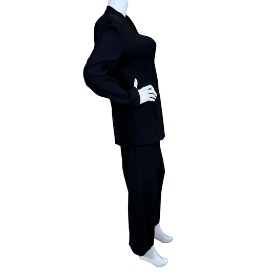 Armani Collezioni Black Suit Set features a sharply tailored longline blazer with a structured silhouette, subtle shoulder padding, and a high mandarin collar