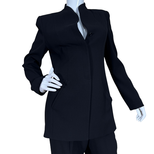 Black suit on a mannequin with white gloves against a white background