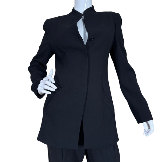 Armani Collezioni Black Suit Set features a sharply tailored longline blazer with a structured silhouette, subtle shoulder padding, and a high mandarin collar