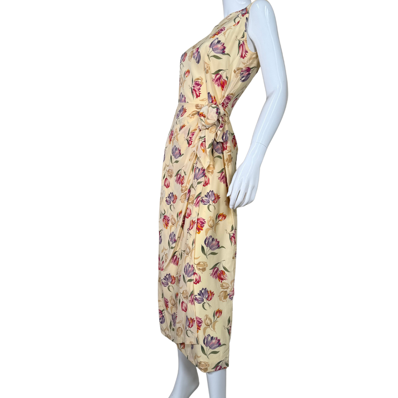 Load image into Gallery viewer, August Silk Floor-length Vibrant Floral Dress is a sleeveless, floor-length piece with a soft cream base adorned with a vibrant floral print
