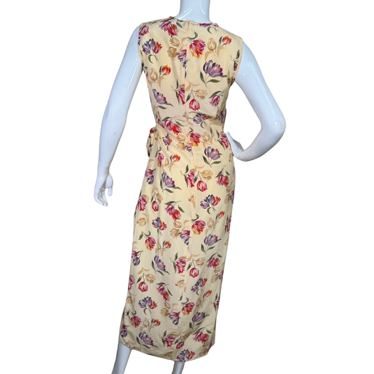 August Silk Floor-length Vibrant Floral Dress is a sleeveless, floor-length piece with a soft cream base adorned with a vibrant floral print
