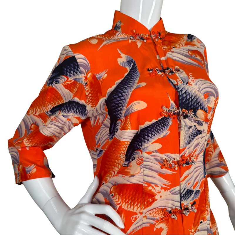 Load image into Gallery viewer, Vibrant and bold, this donated Avanti Bright Orange Silk Shirt with Koi Fish showcases a lively design of koi fish swimming among stylized waves in shades of navy, cream, and orange on a rich red background
