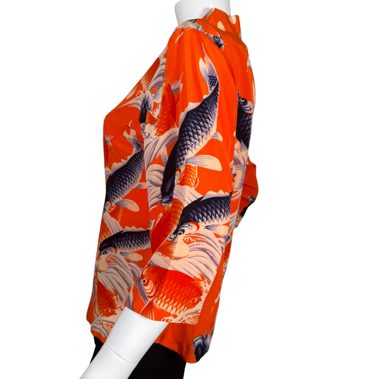Vibrant and bold, this donated Avanti Bright Orange Silk Shirt with Koi Fish showcases a lively design of koi fish swimming among stylized waves in shades of navy, cream, and orange on a rich red background