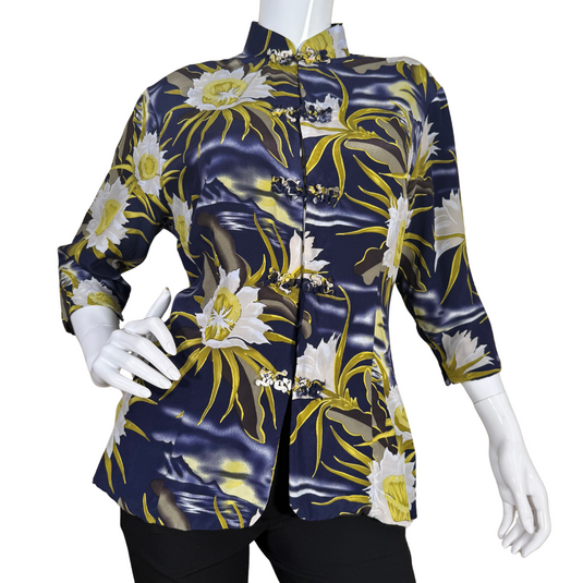 pre-loved Avanti Navy Blue Silk Floral Mandarin Blouse features a striking floral print with large, white and yellow flowers set against a navy blue background with wavy accents, evoking the feel of a moonlit garden.