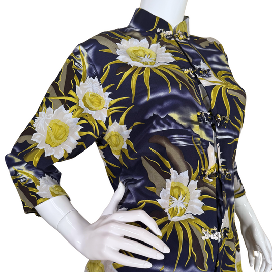 pre-loved Avanti Navy Blue Silk Floral Mandarin Blouse features a striking floral print with large, white and yellow flowers set against a navy blue background with wavy accents, evoking the feel of a moonlit garden.
