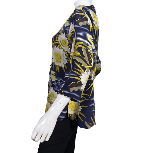 pre-loved Avanti Navy Blue Silk Floral Mandarin Blouse features a striking floral print with large, white and yellow flowers set against a navy blue background with wavy accents, evoking the feel of a moonlit garden.