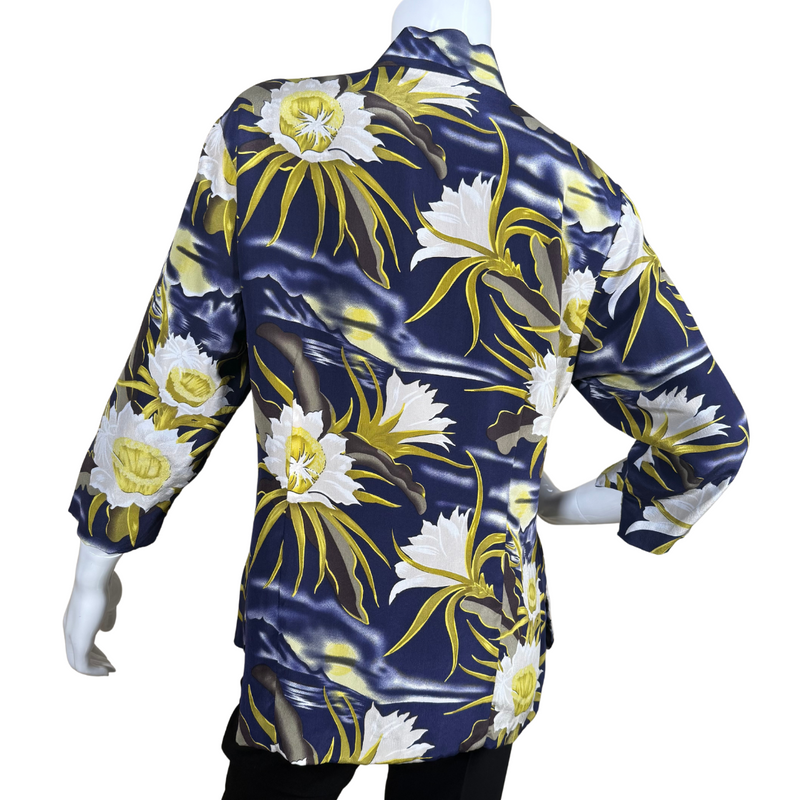 Load image into Gallery viewer, pre-loved Avanti Navy Blue Silk Floral Mandarin Blouse features a striking floral print with large, white and yellow flowers set against a navy blue background with wavy accents, evoking the feel of a moonlit garden.
