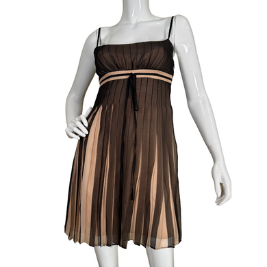 sleeveless thrifted BCBG Maxazria Silk Babydoll Dress with Slitted Sheer Overlay features delicate spaghetti straps and a flattering empire waistline accented by a thin ribbon.